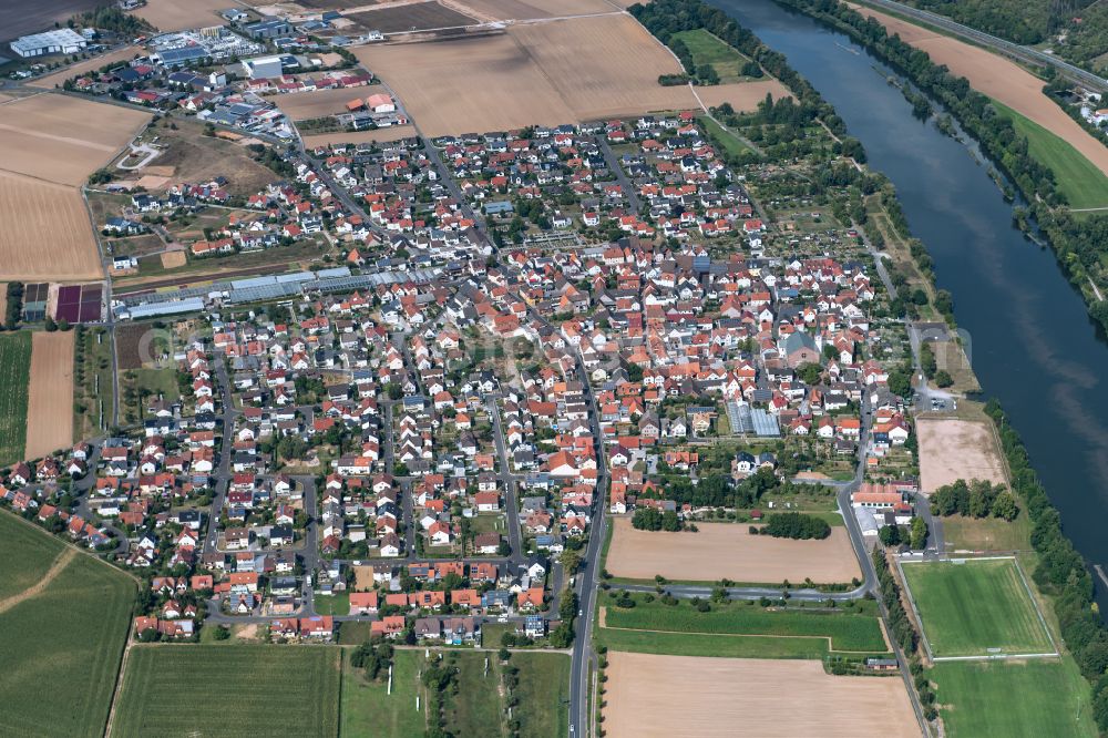 Karlburg from the bird's eye view: Village view on the edge of agricultural fields and land in Karlburg in the state Bavaria, Germany
