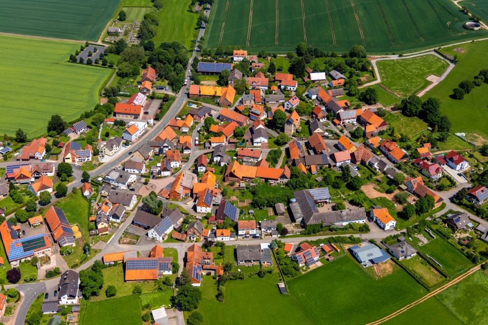 Meineringhausen from the bird's eye view: Village view on the edge of agricultural fields and land in Meineringhausen in the state Hesse, Germany