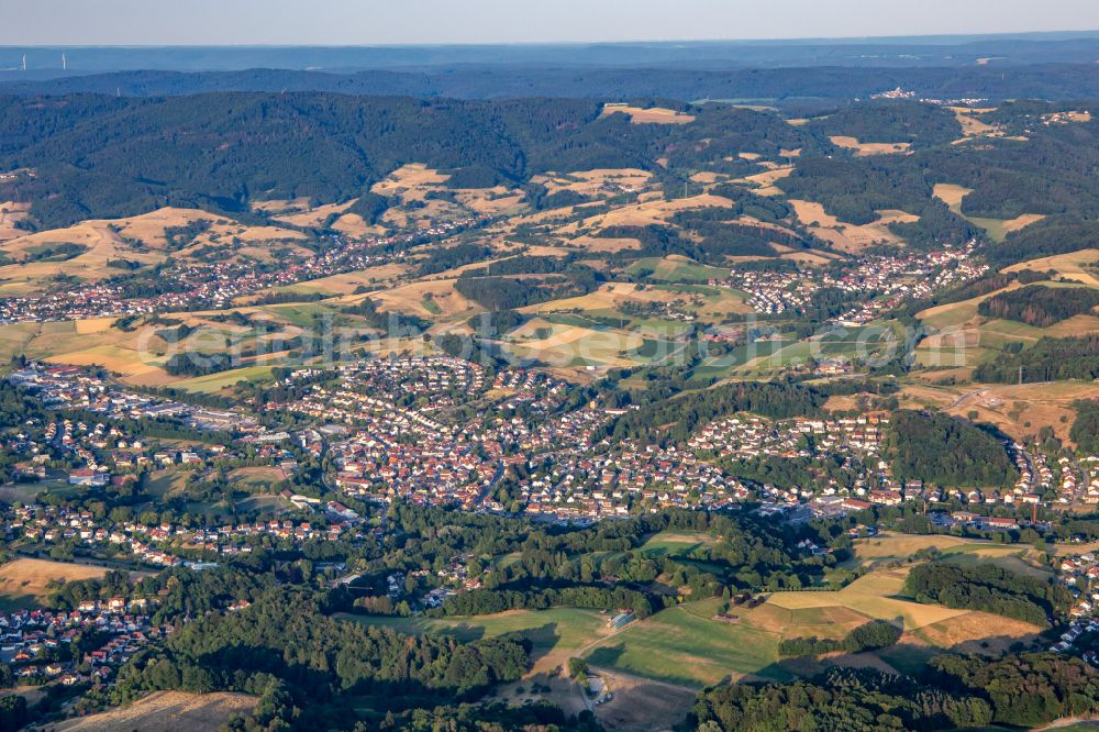 Mörlenbach from the bird's eye view: Village view on the edge of agricultural fields and land on street Friedgasse in Moerlenbach in the state Hesse, Germany