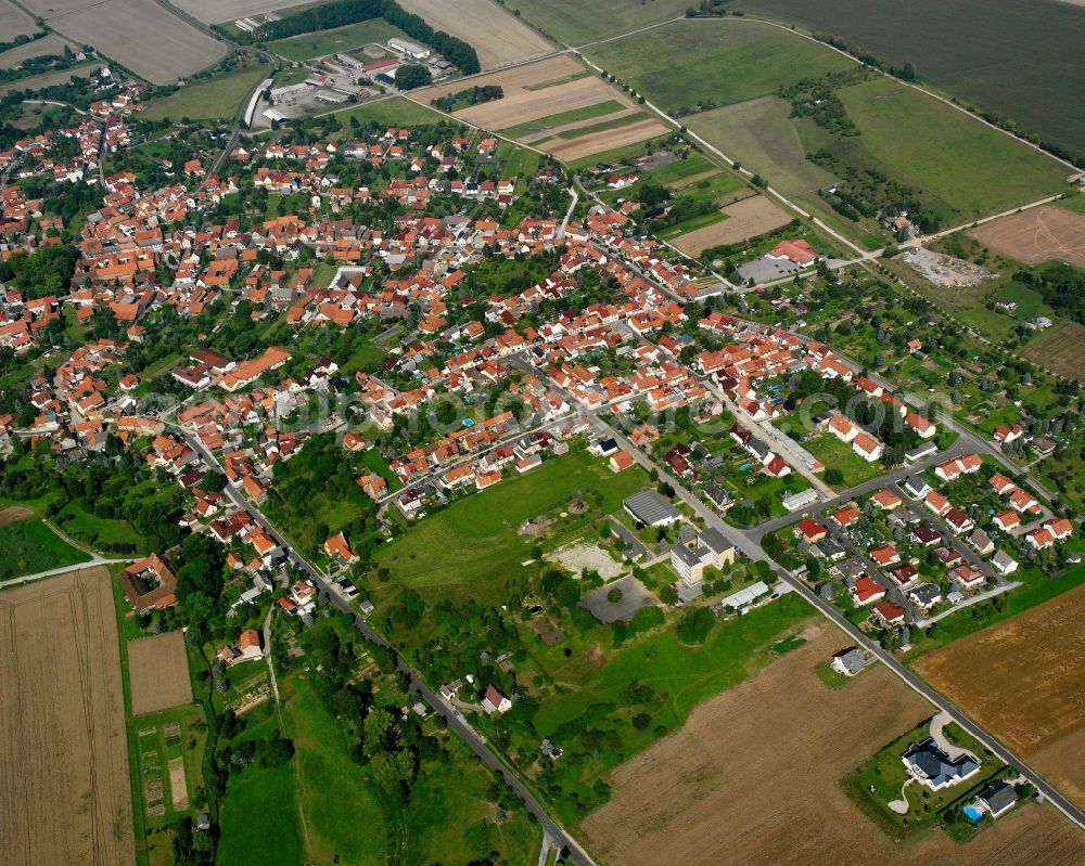 Oberdorla from the bird's eye view: Village view on the edge of agricultural fields and land in Oberdorla in the state Thuringia, Germany