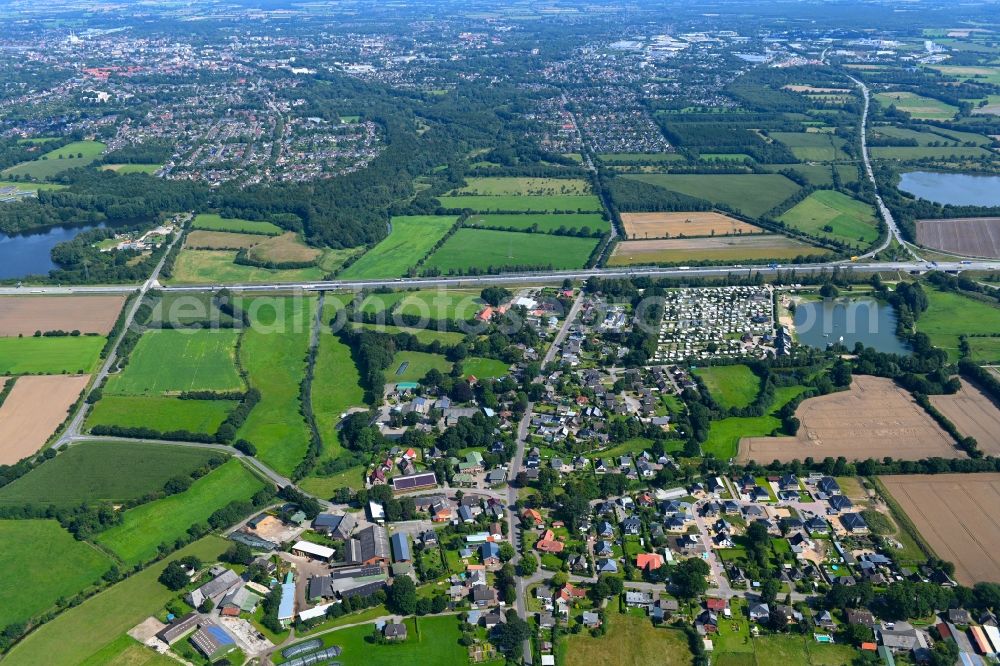 Padenstedt from above - Village view on the edge of agricultural fields and land in Padenstedt in the state Schleswig-Holstein, Germany