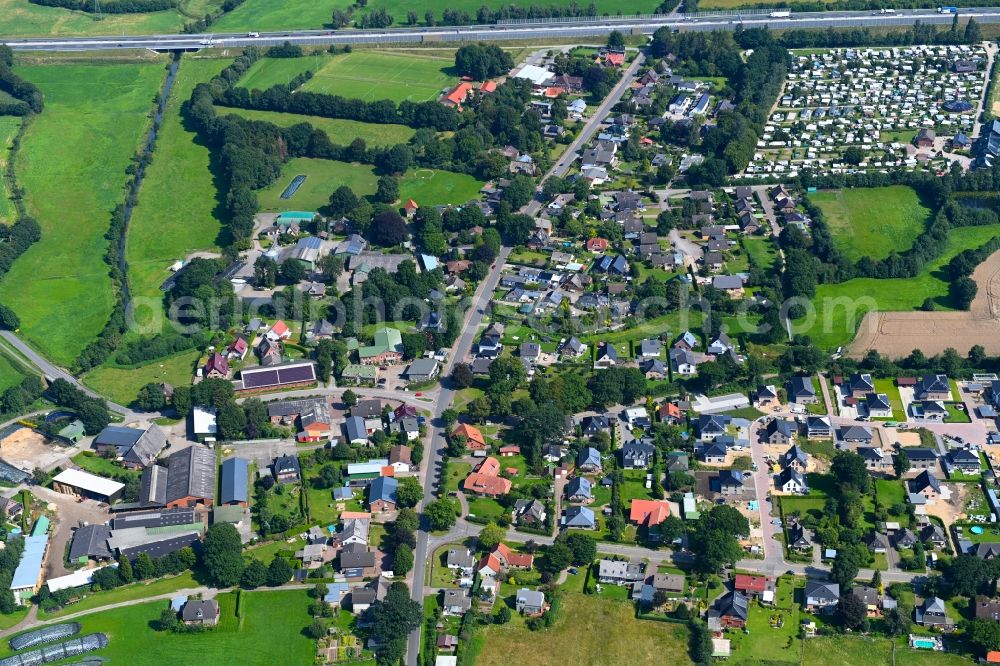 Padenstedt from the bird's eye view: Village view on the edge of agricultural fields and land in Padenstedt in the state Schleswig-Holstein, Germany