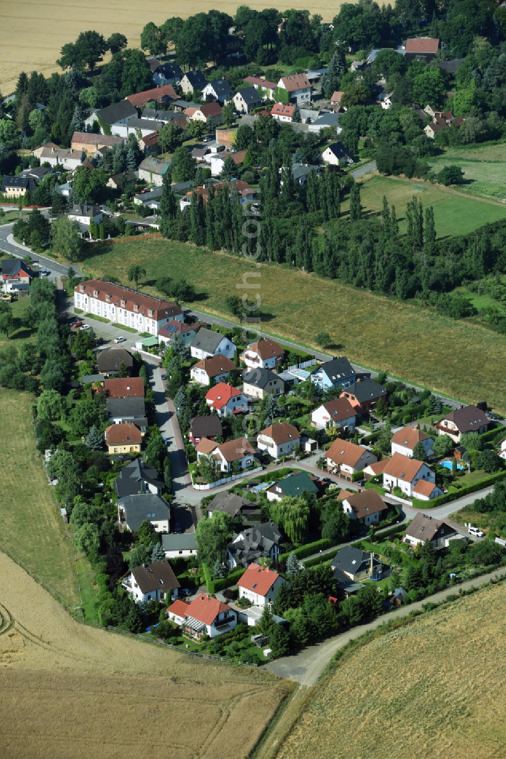 Pönitz from the bird's eye view: Village view on the edge of agricultural fields and land on street Alte Dorfstrasse in Poenitz in the state Saxony, Germany