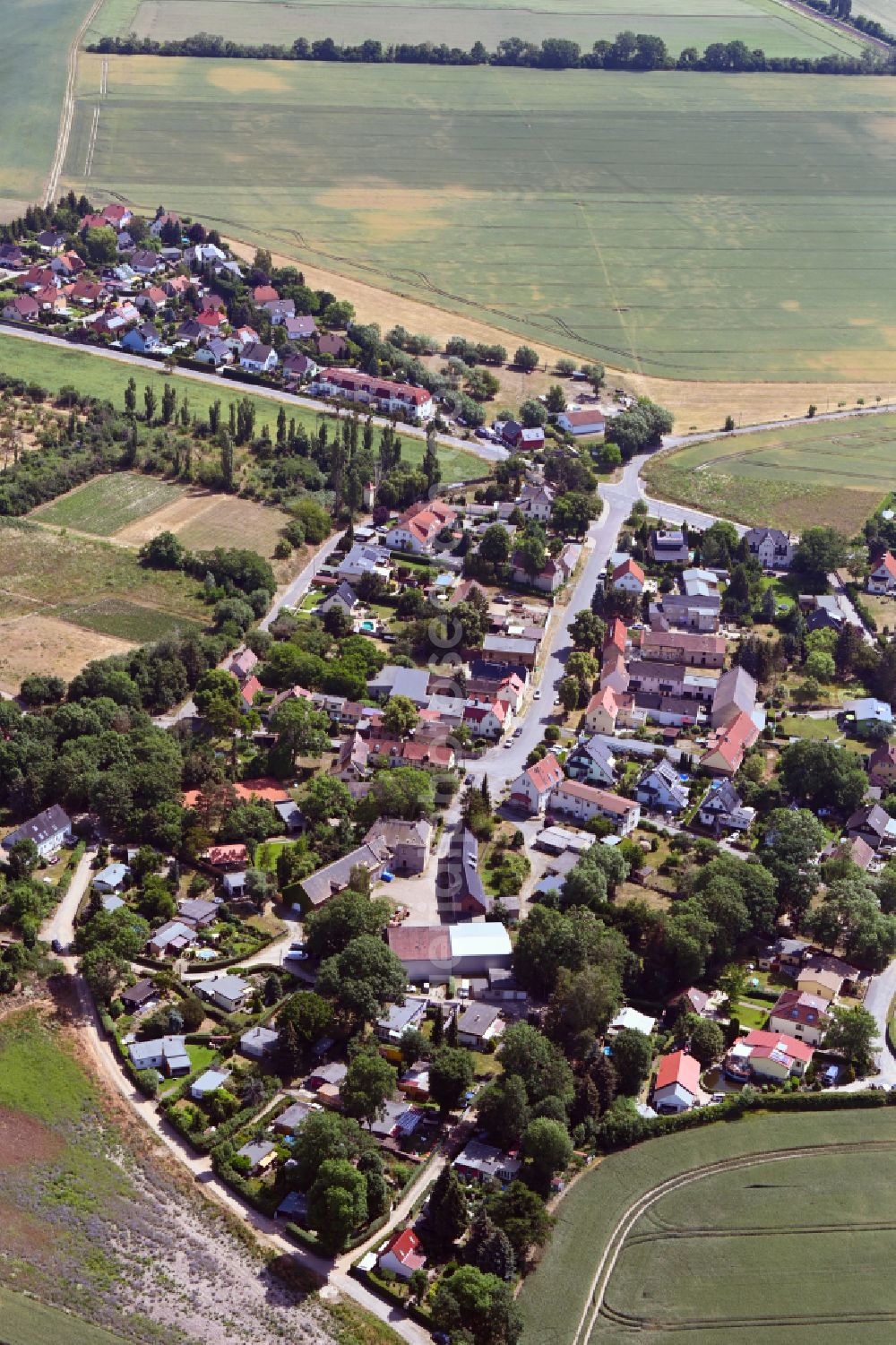 Pönitz from above - Village view on the edge of agricultural fields and land on street Alte Dorfstrasse in Poenitz in the state Saxony, Germany