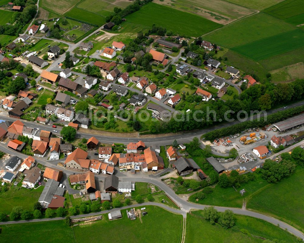 Queck from the bird's eye view: Village view on the edge of agricultural fields and land in Queck in the state Hesse, Germany