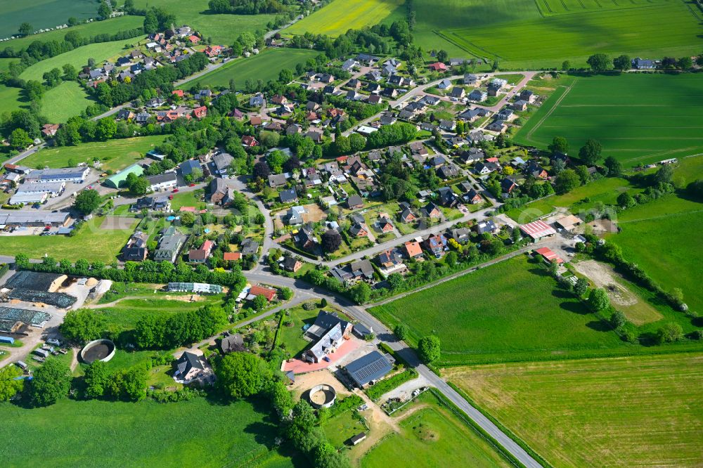 Aerial photograph Stuvenborn - Village view on the edge of agricultural fields and land in Stuvenborn in the state Schleswig-Holstein, Germany