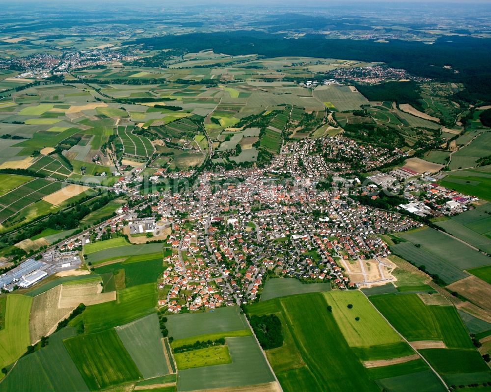 Sulzfeld from the bird's eye view: Village view on the edge of agricultural fields and land in Sulzfeld in the state Baden-Wuerttemberg, Germany