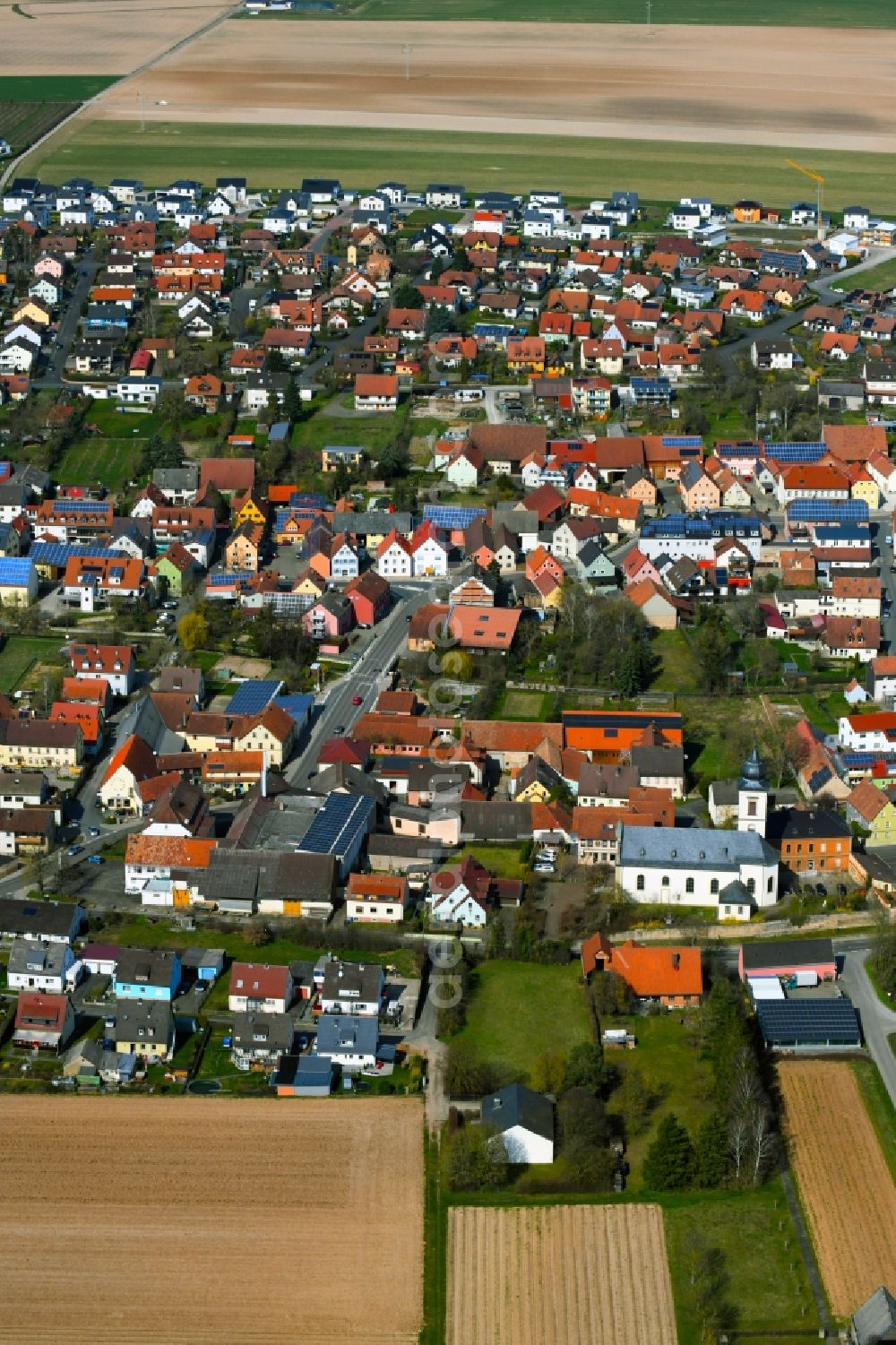 Aerial image Unterpleichfeld - Town view with streets, houses and residential areas on the edge of agricultural fields and usable areas in Unterpleichfeld in the state Bavaria, Germany