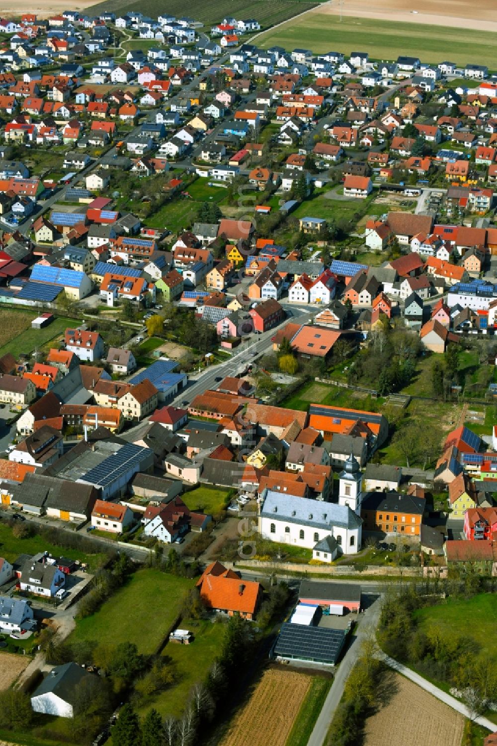 Aerial photograph Unterpleichfeld - Town view with streets, houses and residential areas on the edge of agricultural fields and usable areas in Unterpleichfeld in the state Bavaria, Germany