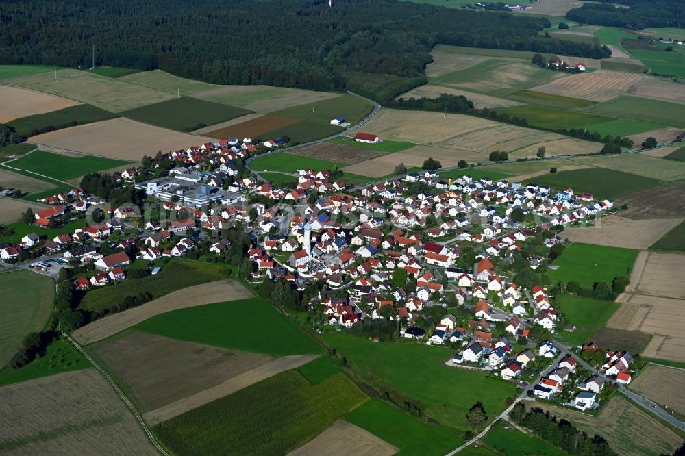 Wiedenzhausen from the bird's eye view: Village view on the edge of agricultural fields and land in Wiedenzhausen in the state Bavaria, Germany