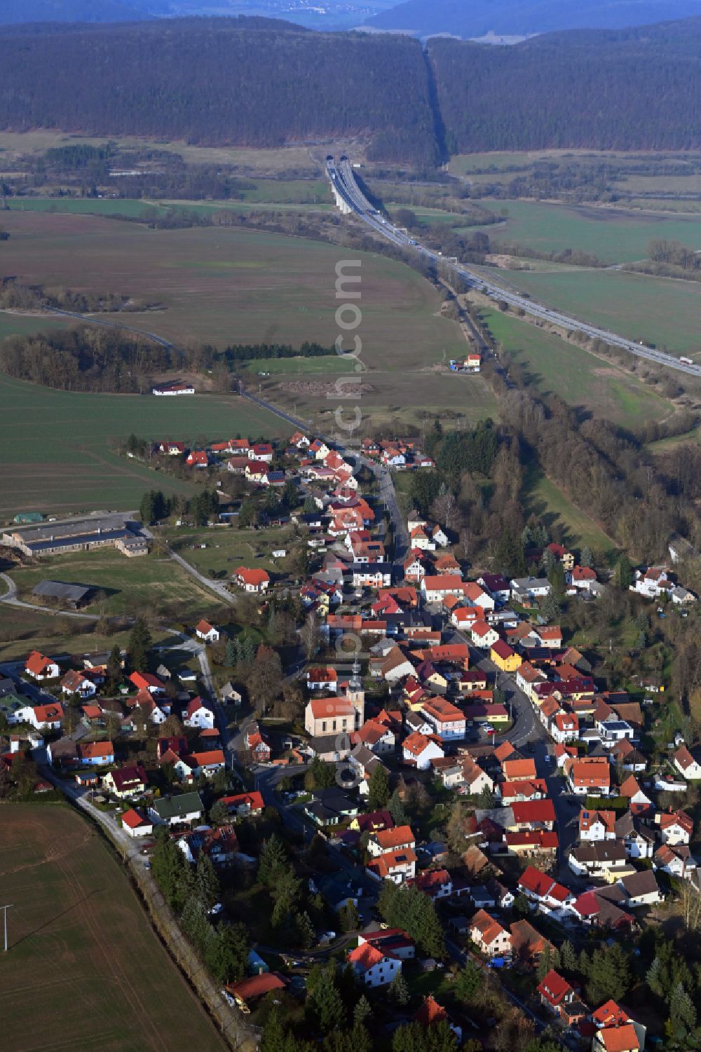 Wölfershausen from the bird's eye view: Village view on the edge of agricultural fields and land in Woelfershausen in the state Thuringia, Germany
