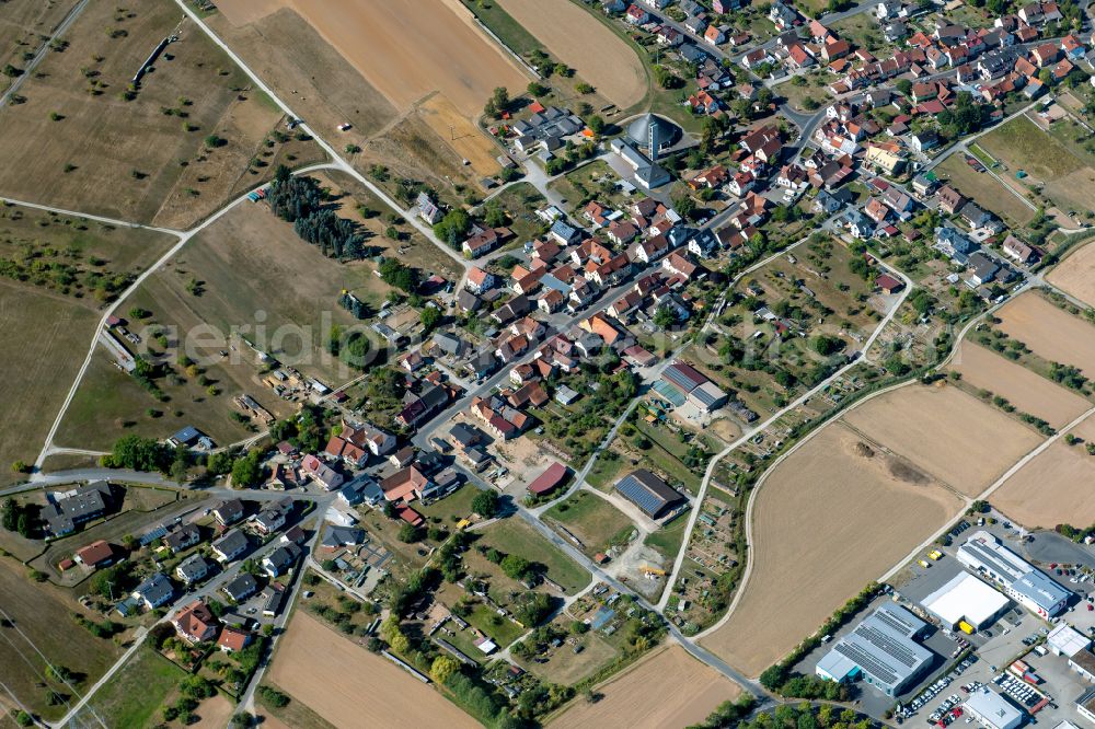 Wombach from the bird's eye view: Village view on the edge of agricultural fields and land in Wombach in the state Bavaria, Germany
