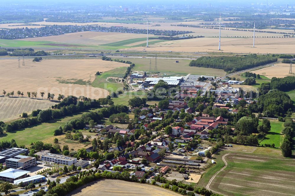 Panketal from the bird's eye view: Agricultural land and field boundaries surround the settlement area of the village in the district Schwanebeck in Panketal in the state Brandenburg, Germany