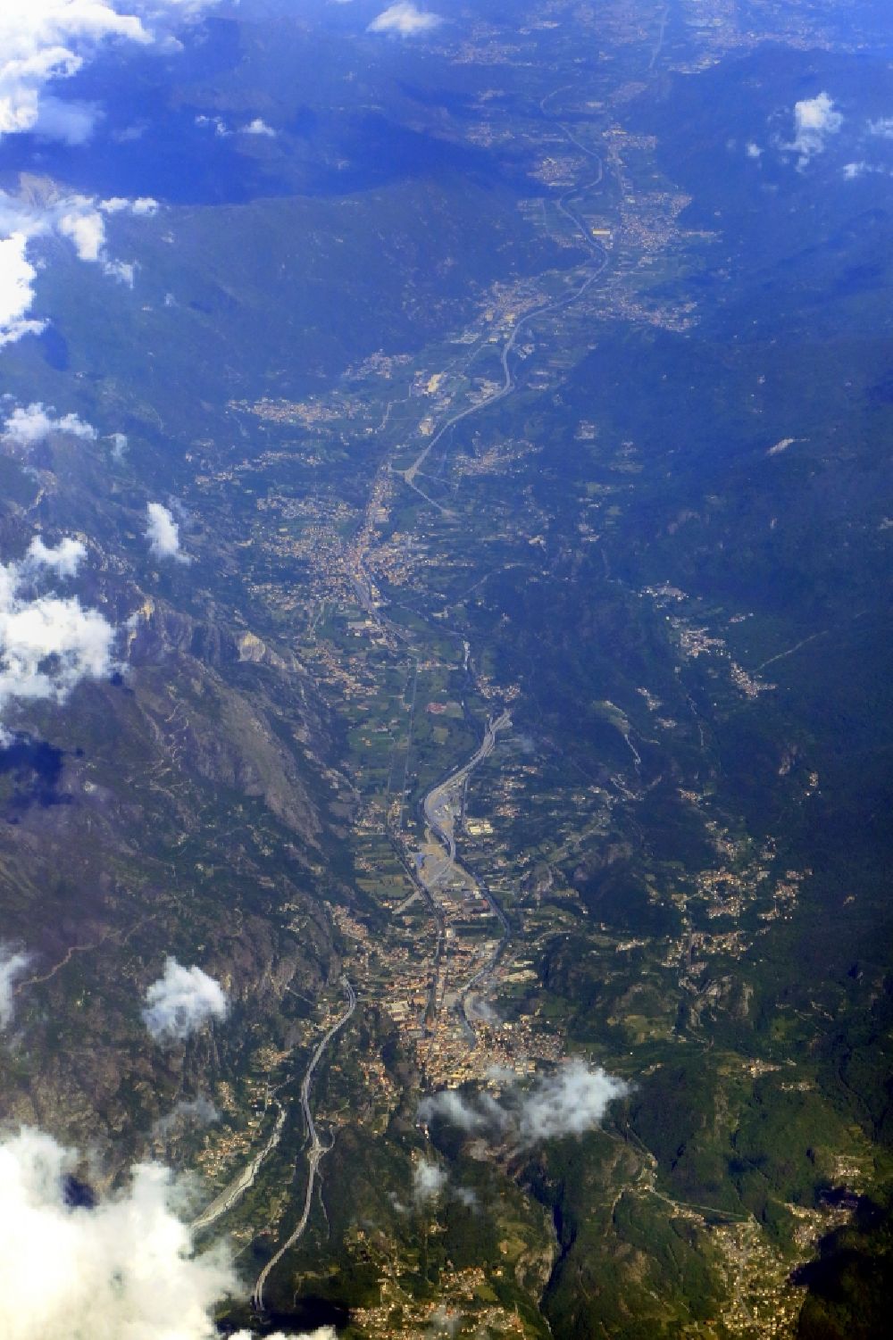 Aerial image Susa - Location view of the streets and houses in the valley landscape Val di Susa surrounded by mountains in Susa in Piemont, Italy