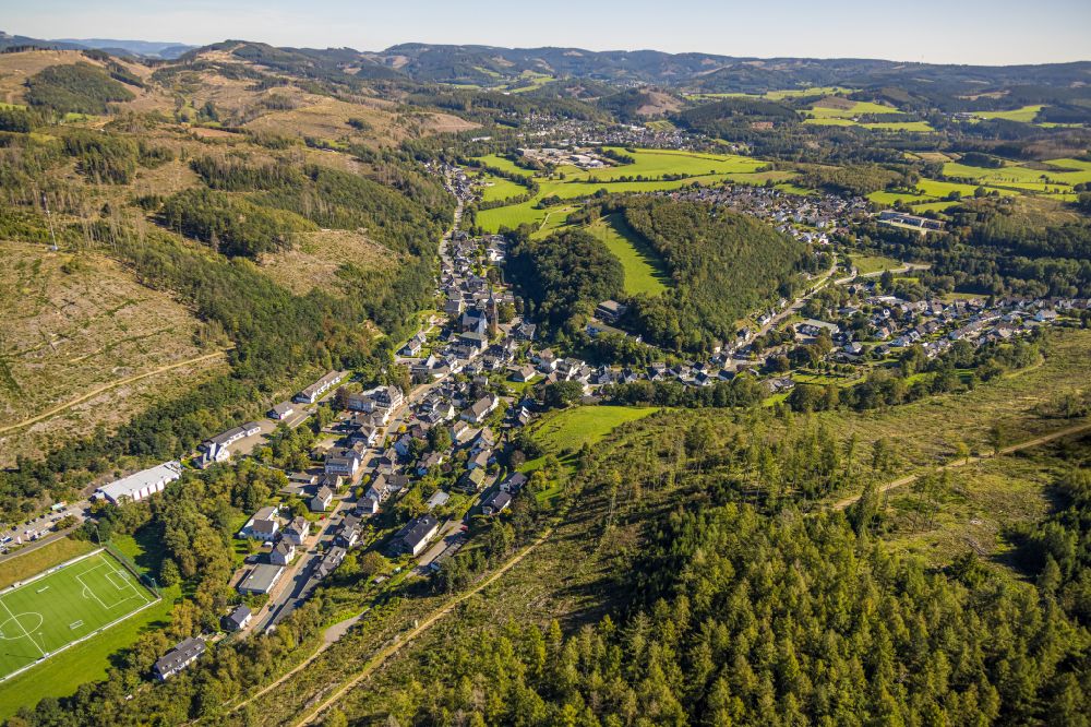 Aerial image Kirchhundem - Location view of the streets and houses of residential areas in the valley landscape surrounded by mountains in Kirchhundem at Sauerland in the state North Rhine-Westphalia, Germany