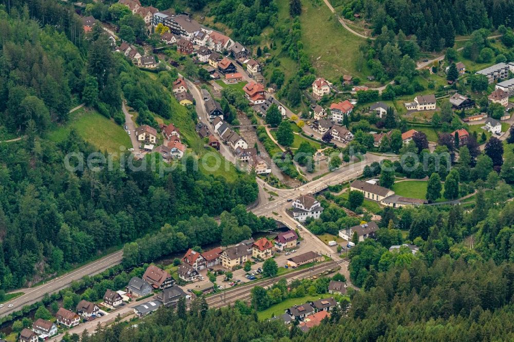 Schönmünzach from the bird's eye view: Location view of the streets and houses of residential areas in the valley landscape surrounded by mountains in Schoenmuenzach in the state Baden-Wuerttemberg, Germany