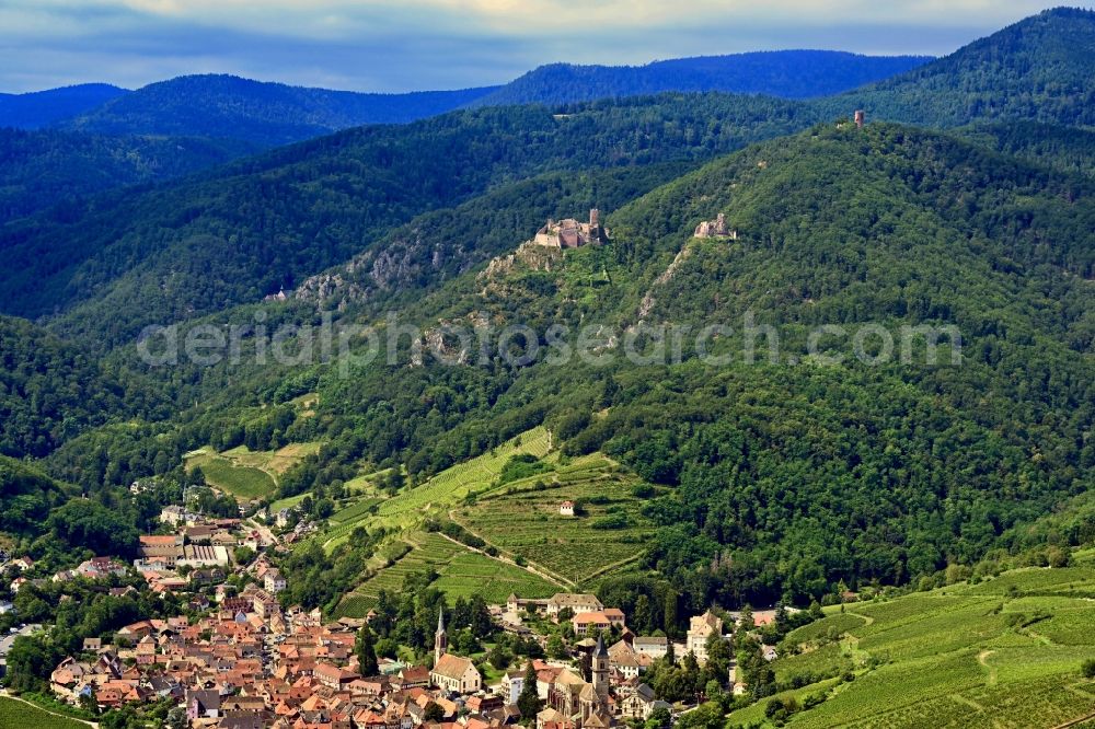Ribeauville from above - Location view of the streets and houses of residential areas in the valley landscape surrounded by mountains in Ribeauville in Grand Est, France