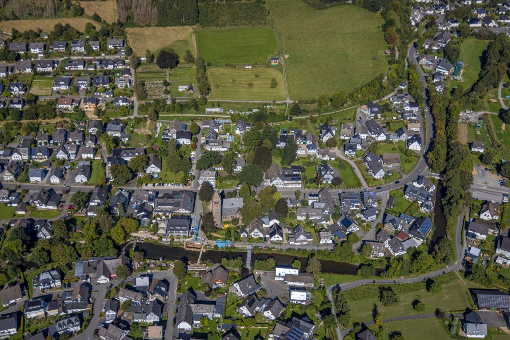 Saalhausen from above - Location view of the streets and houses of residential areas in the valley landscape surrounded by mountains on street Auf der Stenn in Saalhausen in the state North Rhine-Westphalia, Germany