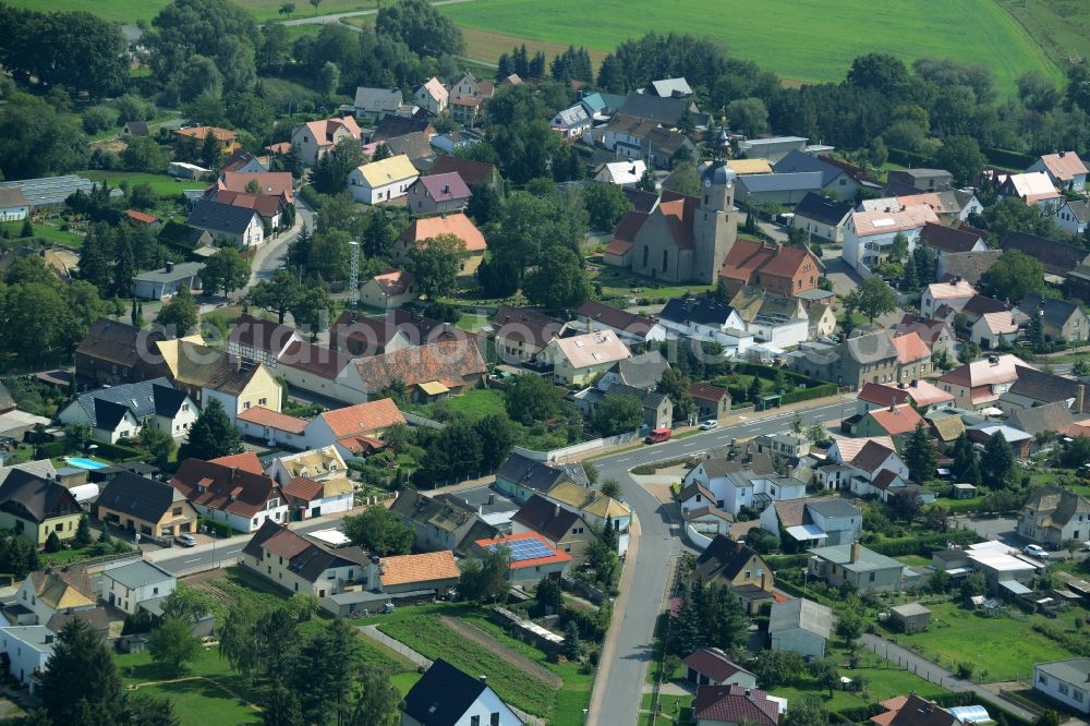 Aerial photograph Zschepplin - View of the borough of Zschepplin in the state of Saxony. The borough is located in the county district of North Saxony, surrounded by hills and fields and consists of residential buildings. The church St.Lucia is located in its centre