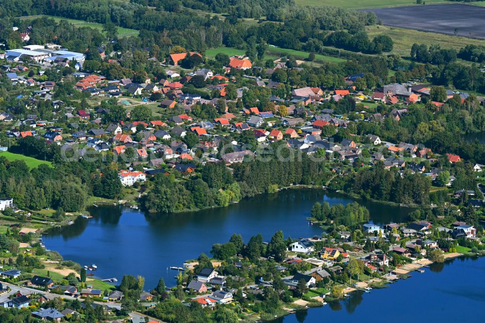 Güster from the bird's eye view: Village on the banks of the area lake of Pruesssee in Guester in the state Schleswig-Holstein, Germany