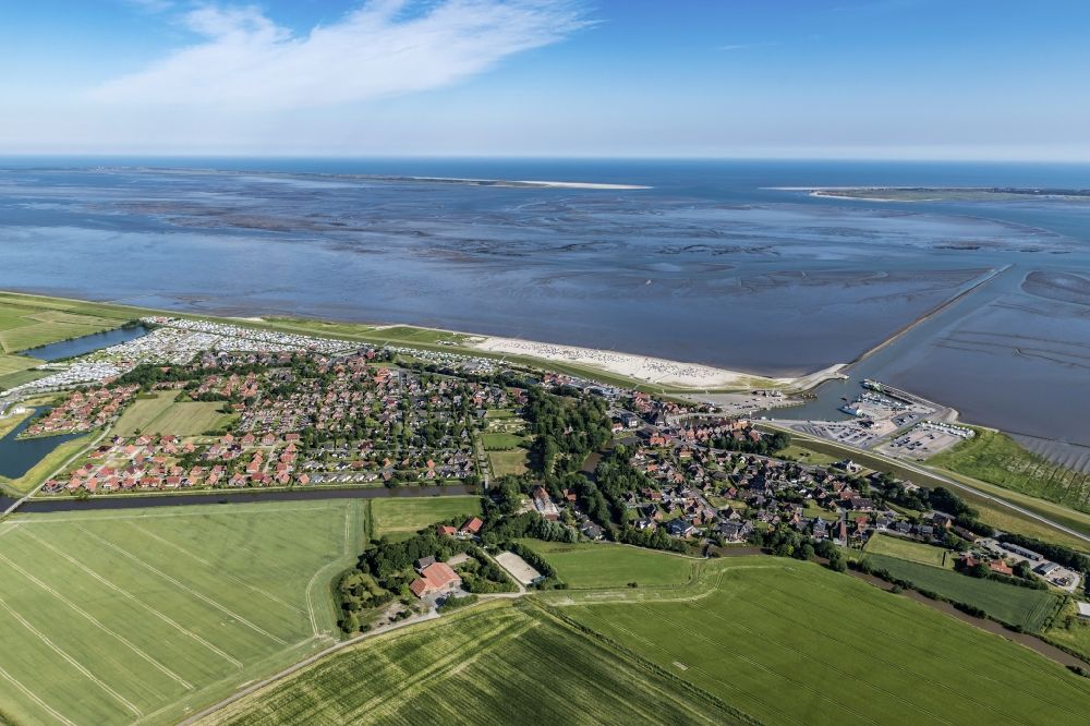 Aerial image Neuharlingersiel - East Frisian Coast in Neuharlingersiel in the state of Lower Saxony. The borough of Neuharlingersiel is located in Harlinger Land in East Frisia on the North Sea shore. The coastal line consists of the Lower Saxony Wadden Sea which has been named a UNESCO world heritage site in 2009. The landscape is characterised by Wadden Sea, agriculture and fields
