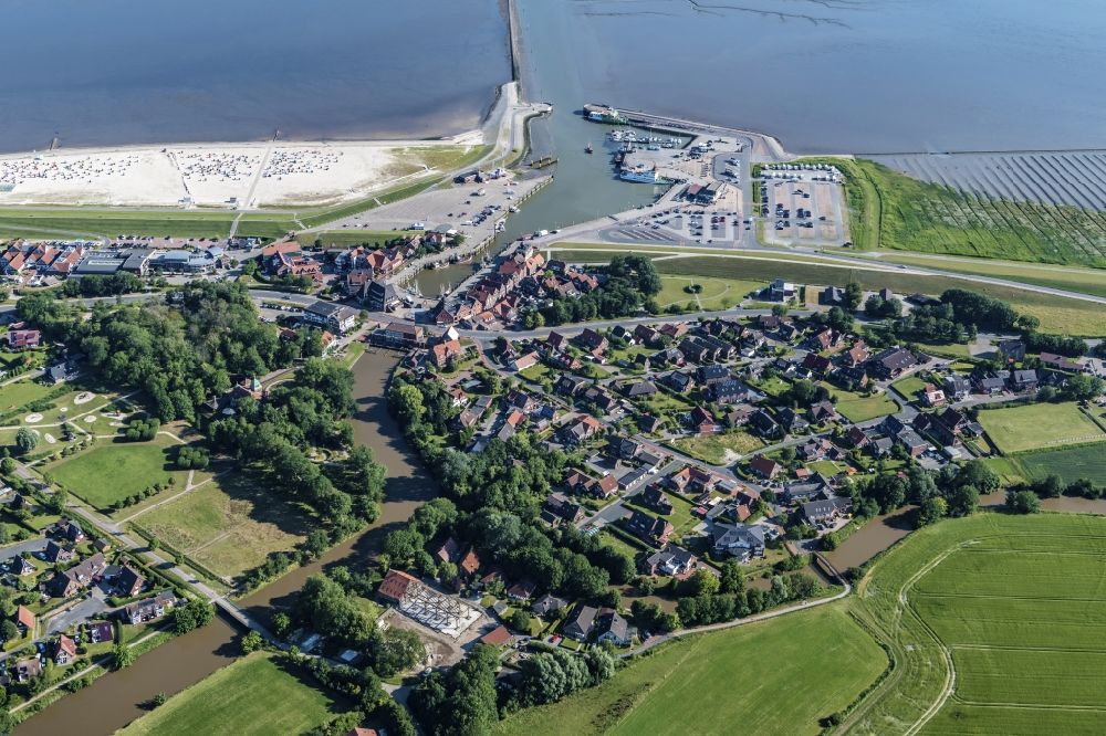 Neuharlingersiel from above - East Frisian Coast in Neuharlingersiel in the state of Lower Saxony. The borough of Neuharlingersiel is located in Harlinger Land in East Frisia on the North Sea shore. The coastal line consists of the Lower Saxony Wadden Sea which has been named a UNESCO world heritage site in 2009. The landscape is characterised by Wadden Sea, agriculture and fields