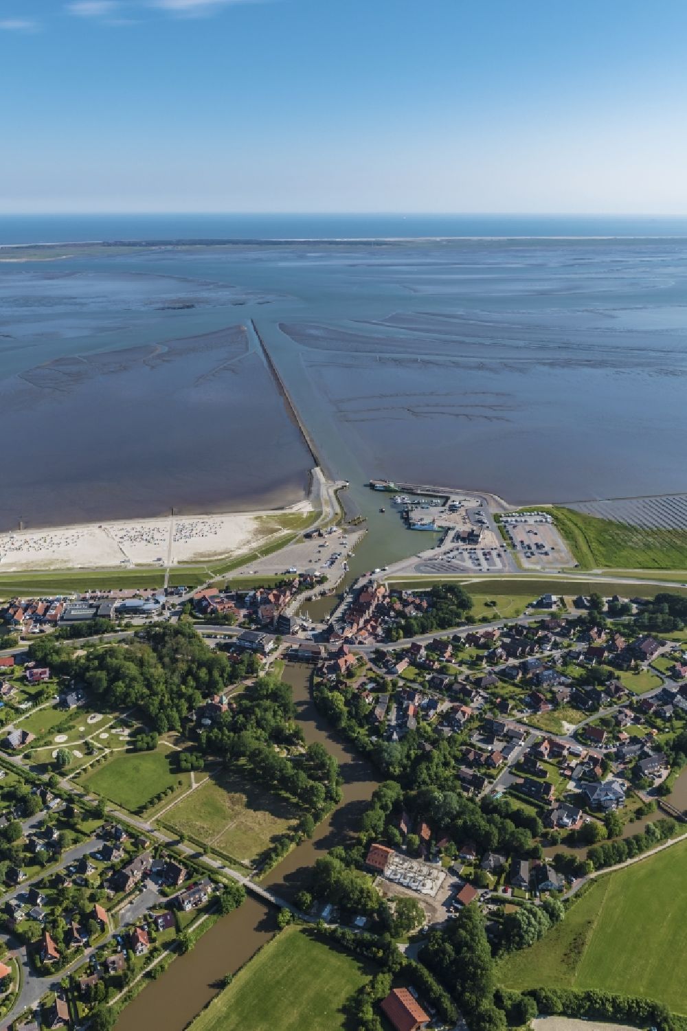 Aerial image Neuharlingersiel - East Frisian Coast in Neuharlingersiel in the state of Lower Saxony. The borough of Neuharlingersiel is located in Harlinger Land in East Frisia on the North Sea shore. The coastal line consists of the Lower Saxony Wadden Sea which has been named a UNESCO world heritage site in 2009. The landscape is characterised by Wadden Sea, agriculture and fields