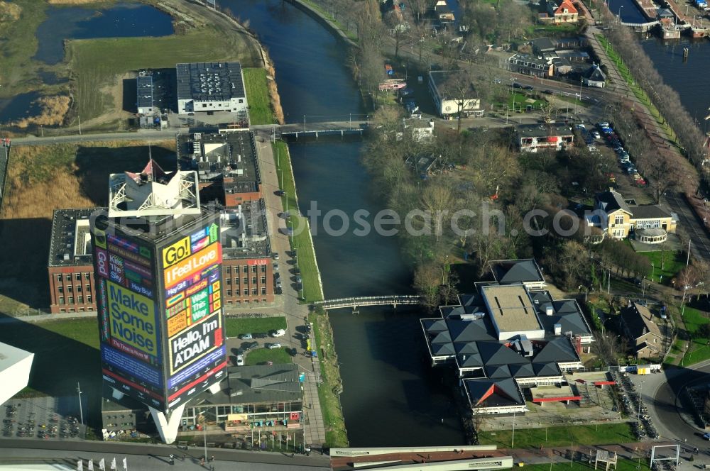 Aerial photograph Amsterdam - District view of Overhoeks and Amsterdam Noord in the province of North Holland in the Netherlands. Overhoeks is a new neighbourhood in the district Buiksloterham at the IJ. In Overhoeks, on the former area of the oil company Shell, are the Overhoeks Tower and the EYE Film Museum located. The bridges Badhuisweg and Tolhuisweg traverse the Buiksloterkanaal