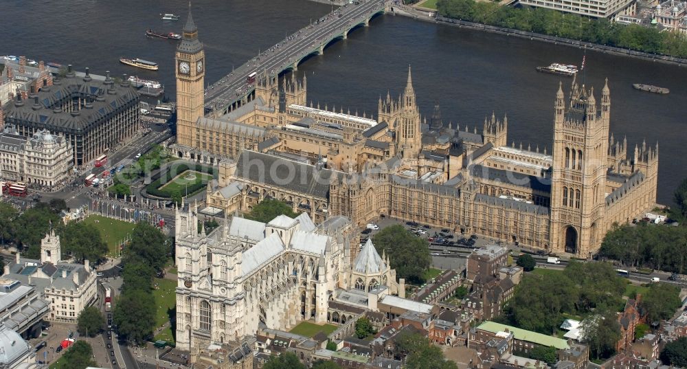 Aerial image London - View of the Palace of Westminster / Westminster Palace in London. monumental, neo-Gothic style building in London where the meeting consists of the House of Commons and the House of Lords, British Parliament. This is under the UNESCO World Heritage landmark located in the City of Westminster on Parliament Square, close to government buildings at Whitehall. The most famous part of the palace is the Clock Tower (Clock Tower), with the bell Big Ben. In the foreground the church of Westminster Abbey