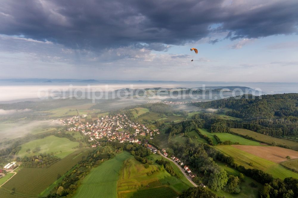 Aerial image Radolfzell am Bodensee - Paraglider before the Lake of Constance hidden by mroning fog over Village - view on the edge of agricultural fields and farmland in the district Guettingen in Radolfzell am Bodensee in the state Baden-Wuerttemberg, Germany