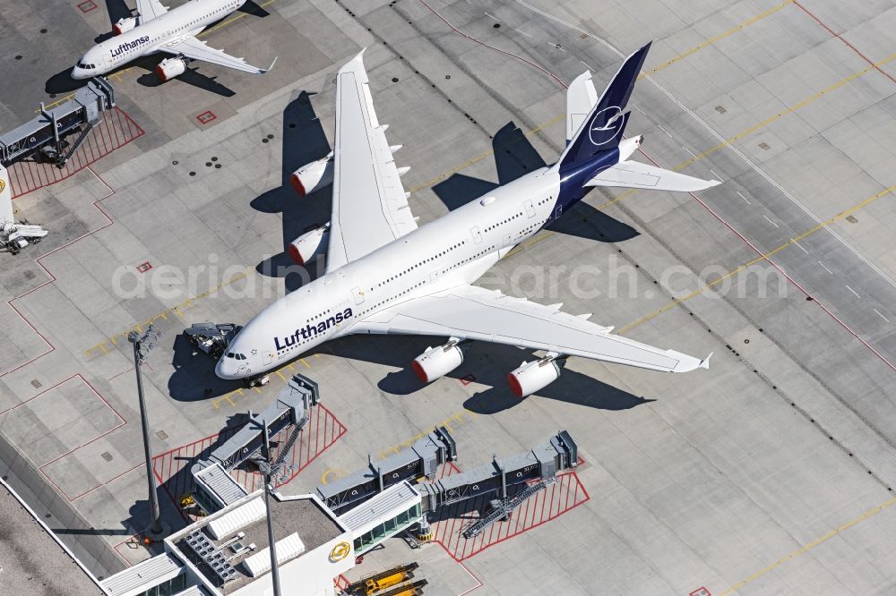 München-Flughafen from the bird's eye view: Parking type A380 aircraft of Lufthansa at the terminal, which must stay on the ground due to the corona lockdown, on the grounds of the airport in Munich Airport in the state Bavaria, Germany