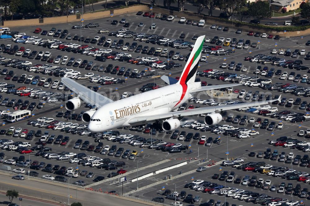 Los Angeles from the bird's eye view: Airliner - Passenger aircraft Airbus A380-800 of the airline Emirates in landing approach the airport in Los Angeles in California, United States of America