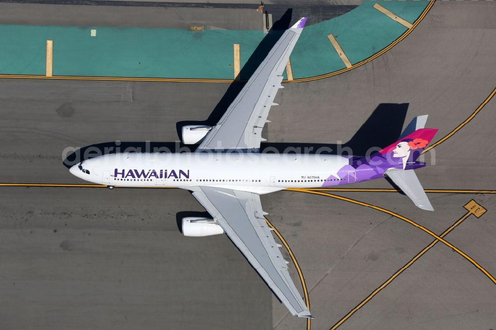 Los Angeles from above - Passenger aircraft Airbus A330-200 of the airline Hawaiian Airlines taxis at the international airport in Los Angeles in California, United States of America