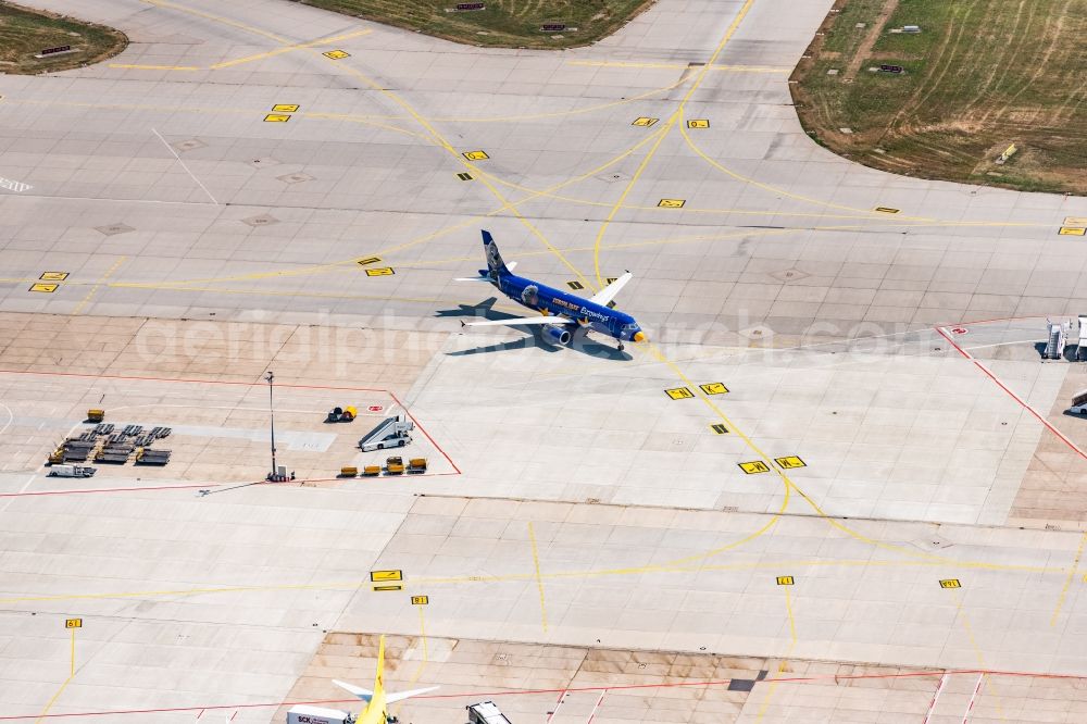 Aerial photograph Stuttgart - Airliner- Passenger aircraft rolling on the apron of the airport in Stuttgart in the state Baden-Wurttemberg, Germany