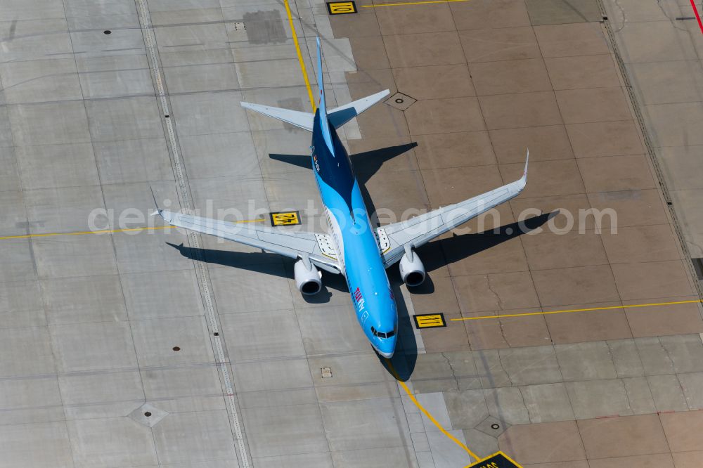 Aerial image Leinfelden-Echterdingen - Passenger aircraft Boeing 737-8K5 D-ATUO of the airline TUI taxiing on the tarmac and apron of the airport in Stuttgart in the state Baden-Wuerttemberg, Germany