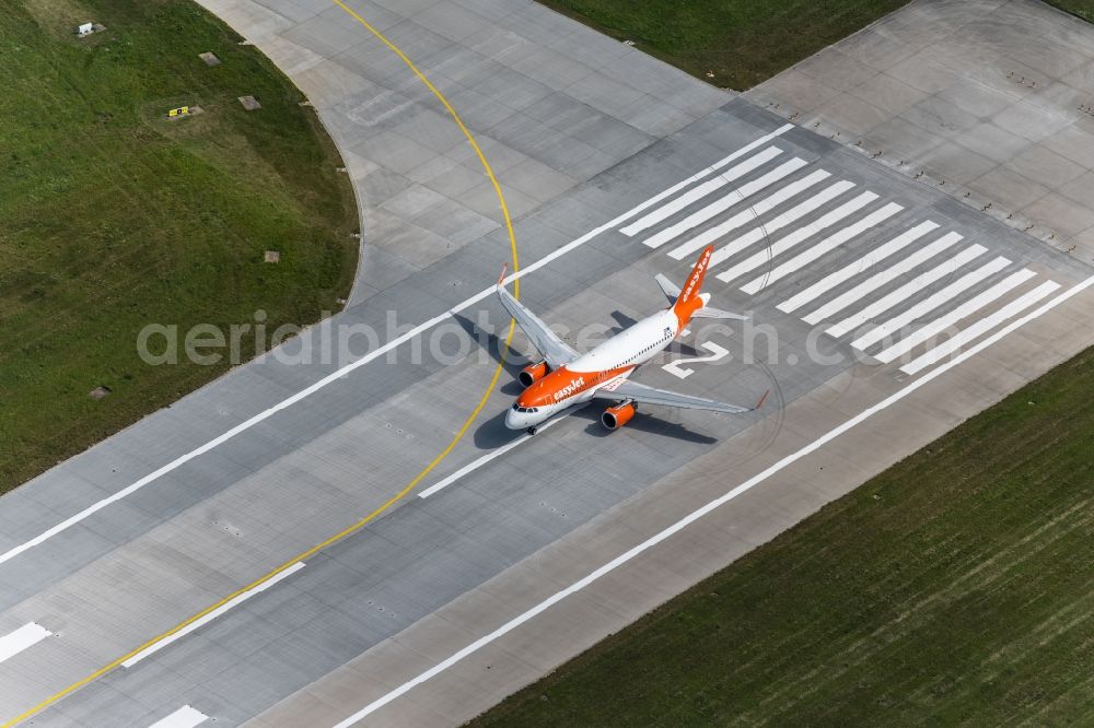 Filderstadt from the bird's eye view: Passenger aircraft with the registration OE-IJS of the airline easyJet Europe of the type Airbus A320-200 taking off at Stuttgart Airport in Filderstadt in the state Baden-Wuerttemberg, Germany