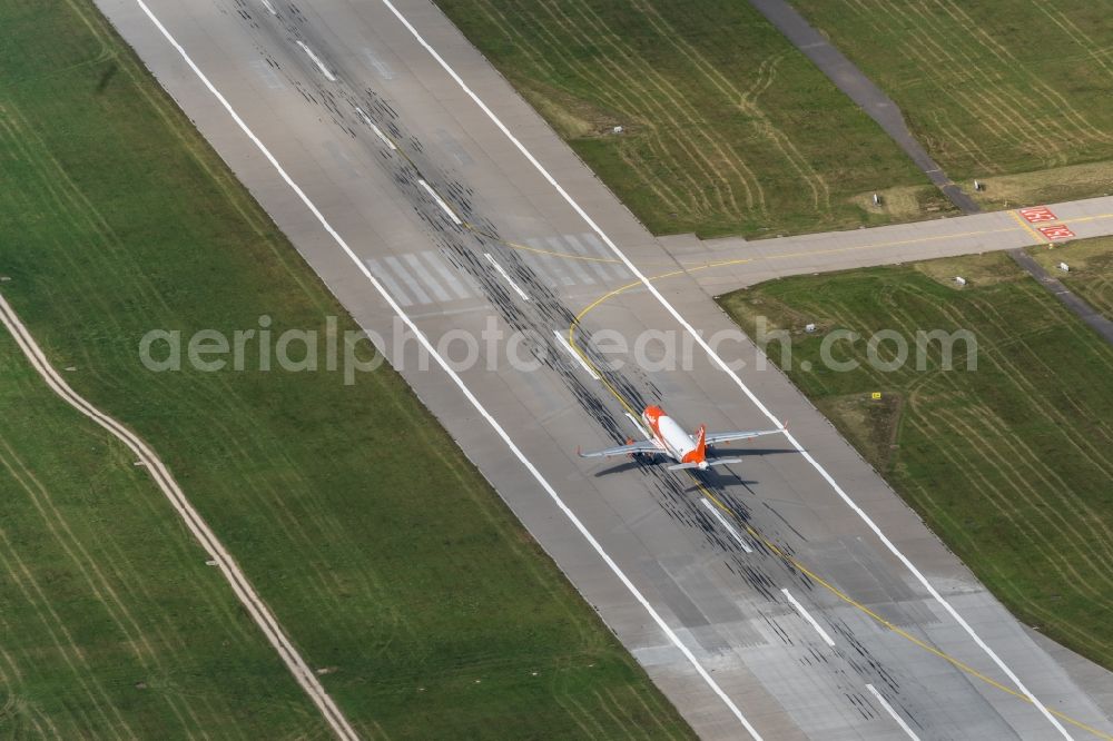 Filderstadt from above - Passenger aircraft with the registration OE-IJS of the airline easyJet Europe of the type Airbus A320-200 taking off at Stuttgart Airport in Filderstadt in the state Baden-Wuerttemberg, Germany