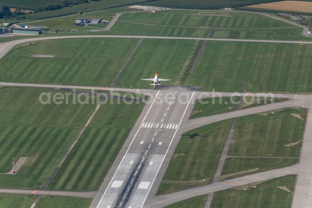 Aerial image Filderstadt - Passenger aircraft with the registration OE-IJS of the airline easyJet Europe of the type Airbus A320-200 taking off at Stuttgart Airport in Filderstadt in the state Baden-Wuerttemberg, Germany