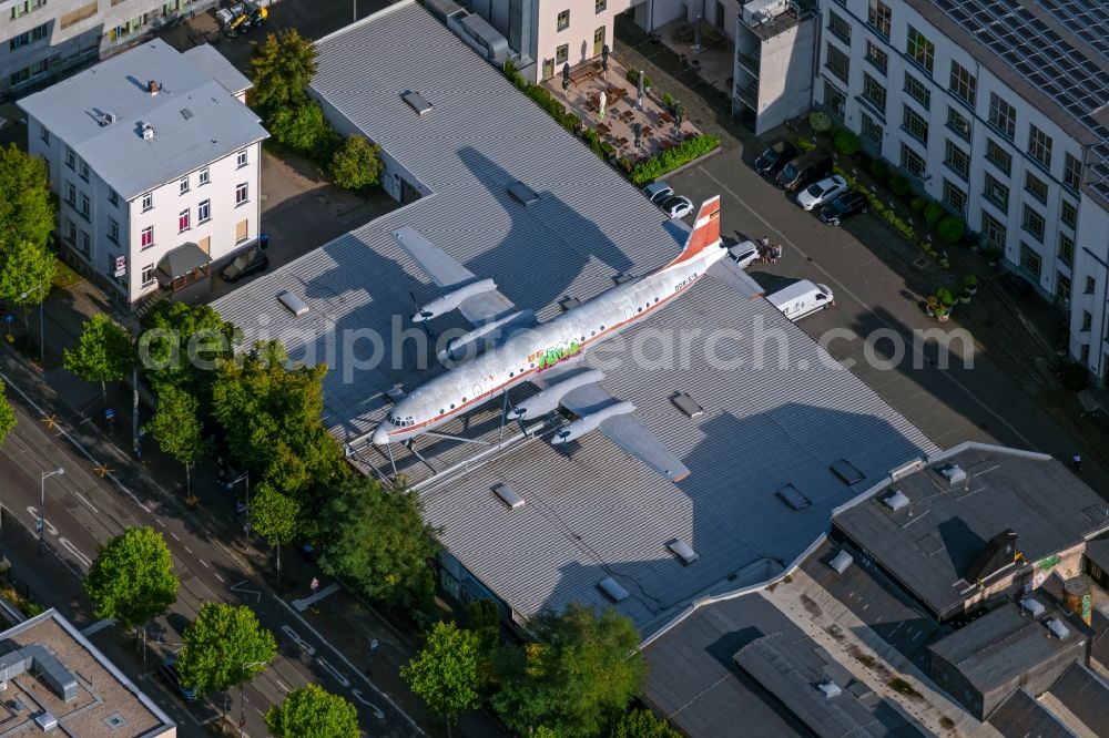 Leipzig from above - Passenger aircraft Ilyushin IL-18W of the former GDR airline INTERFLUG with the identification DDR-STB on the roof of an industrial hall on Karl-Heine-Strasse in the Plagwitz district of Leipzig in the state Saxony, Germany