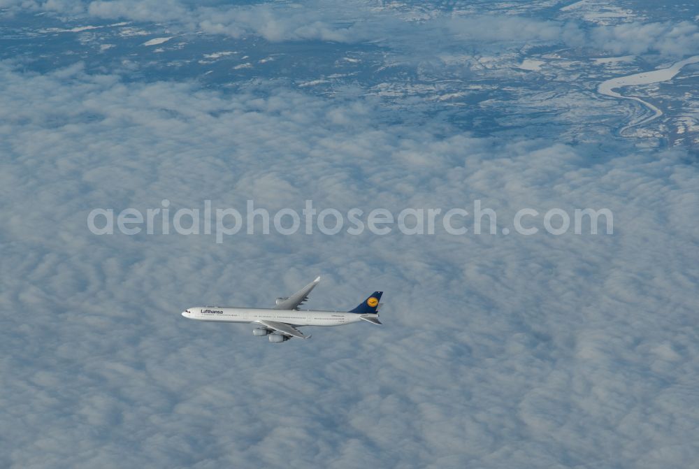 Aerial photograph Kangerlussuaq - Airliner Lufthansa Airbus A340 on the fly over the airspace in Kangerlussuaq in Kitaa, Greenland