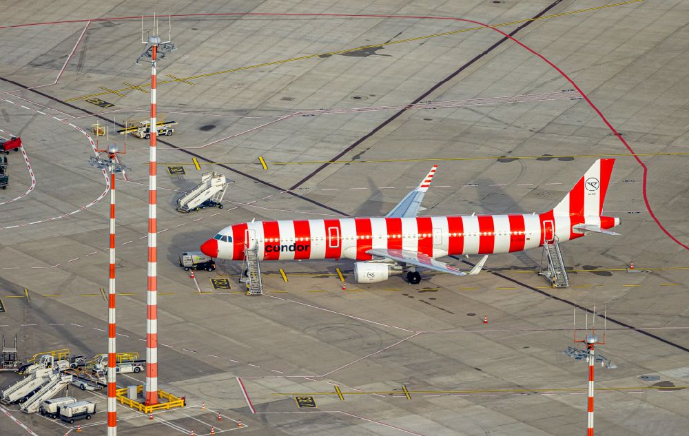 Düsseldorf from above - Red - white striped painted CONDOR AIRBUS A321-200 - passenger aircraft with the identification D-ATCG in the parking position - parking area at the airport in the Lohausen district in Duesseldorf in the Ruhr area in the state North Rhine-Westphalia, Germany