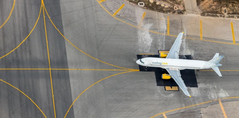 Palma from the bird's eye view: Passenger airplane of VUELING AIRLINES S.A. in parking position - parking area at the airport in the district Llevant de Palma District in Palma in Balearische Insel Mallorca, Spain