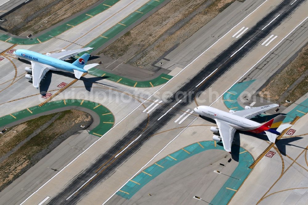 Aerial photograph Los Angeles - Passenger aircraft Airbus A380-800 of the airlines Korean Air and Asiana taxi at the international airport in Los Angeles in California, United States of America