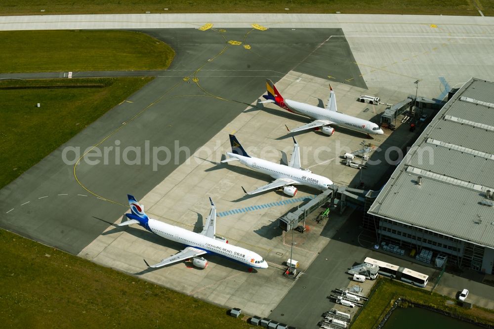 Laage from above - Brand new Airbus A321-253NX passenger aircraft parked for export to China - parked due to the crisis - parking space at the airport in Laage in the state of Mecklenburg-West Pomerania, Germany
