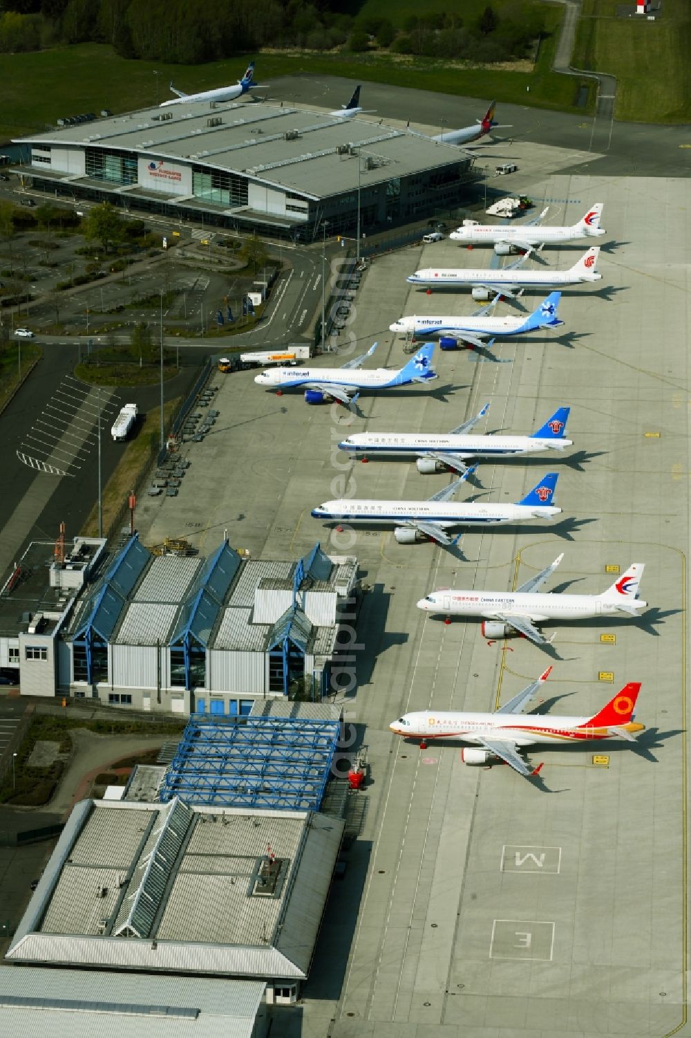 Laage from the bird's eye view: Brand new Airbus A321-253NX passenger aircraft parked for export to China - parked due to the crisis - parking space at the airport in Laage in the state of Mecklenburg-West Pomerania, Germany