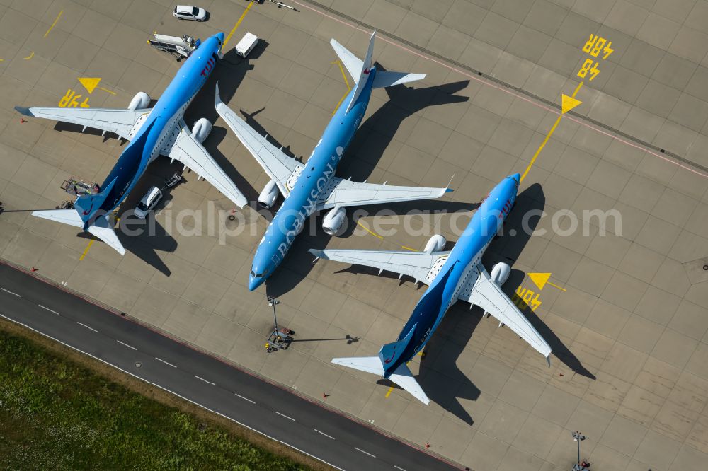 Langenhagen from above - Passenger airplane of Typs Boeing 737-8K5 of the airlines TUI and Robinson in parking position - parking area at the airport in Langenhagen in the state Lower Saxony, Germany
