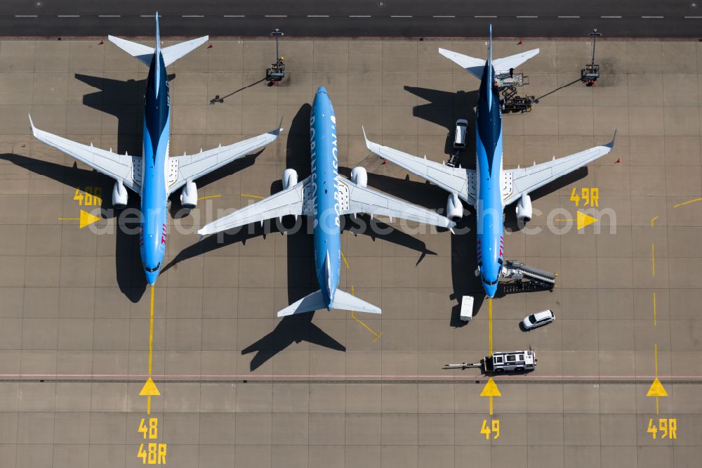 Langenhagen from the bird's eye view: Passenger airplane of Typs Boeing 737-8K5 of the airlines TUI and Robinson in parking position - parking area at the airport in Langenhagen in the state Lower Saxony, Germany