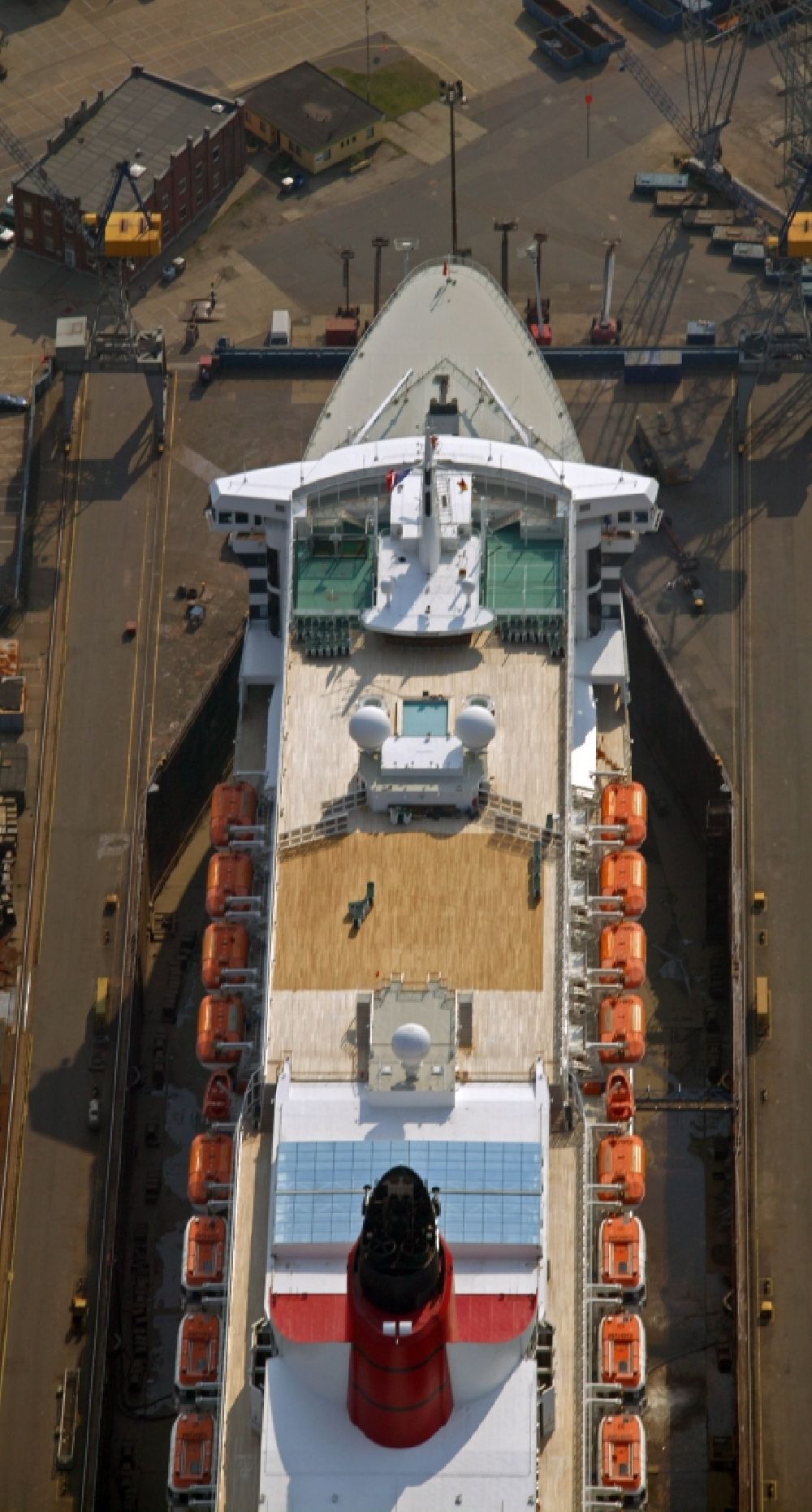 Hamburg from above - Passenger ship and luxury liner Queen Mary 2 on the Elbe 17 dry dock of Blohm and Voss in Hamburg company for maintenance and repairs. It is at 345 meters, the largest passenger ship in the world. The German shipyard Blohm and Voss is a subsidiary of ThyssenKrupp AG