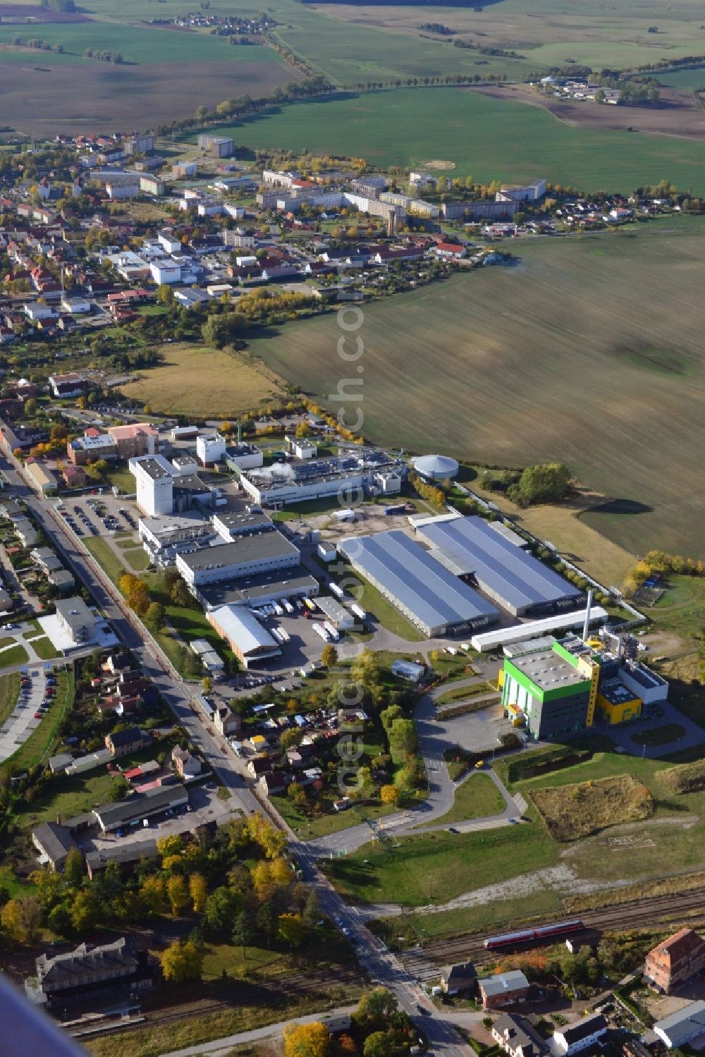 Stavenhagen from above - View at the Pfanni factory premises and the company own power plant in Stavenhagen in the federal state Mecklenburg-Vorpommern. The Pfanni GmbH & Co. OHG is a German food company headquartered in Stavenhagen, which is specialized in the manufacture of kitchen-ready potato products. The power plant was built for the power and heating supply of the Pfanni company and is operated with alternative fuels. Operator is the Nehlsen Heizkraftwerke GmbH & Co.KG