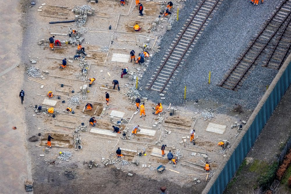 Oberhausen from the bird's eye view: Apprentices in practical vocational training on a construction site for laying paving stones as flooring on a training construction site at the Gartendom in Oberhausen in the Ruhr area in the state North Rhine-Westphalia, Germany
